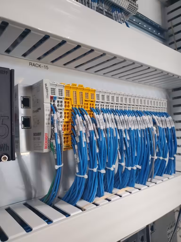 Beckhoff EtherCAT coupler and I/O terminals with labeled blue DC control wiring, the NFPA 79 color for DC control